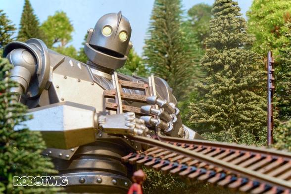 Iron Giant picks up a tram track to eat, Hogarth tells him off