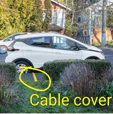 Image from City of Victoria EV charging website showing car, with charging cable cover crossing sidewalk.