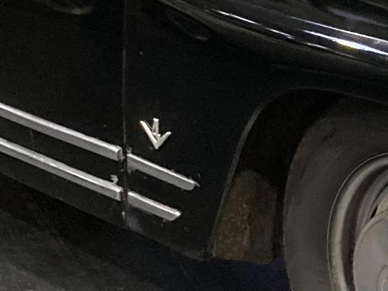 Black Saab 96, V4 badge on front wing