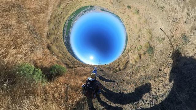 A desert mountain hiking trail scene from the Tri-Cities area of eastern Washington State under clear blue skies.