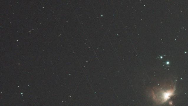 Early part of a photomosaic, showing part of the Orion Nebula. The sky is criss crossed with multiple satellite trails.