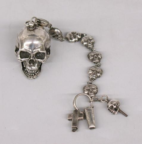 Photo: silver pocket watch with a skull and skull chain