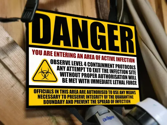 A metal sign warning that you are entering an area of active infection, and that lethal consequences will occur.