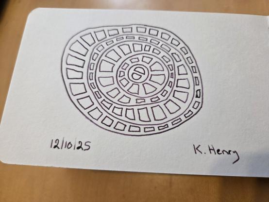 Hand drawn generative/procedural art in ink on an open page of my sketchbook. The abstract pattern has concentric and uneven circles with rectangular shapes inside each ring.