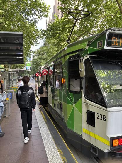 Tram stop with minimal waiting passengers.