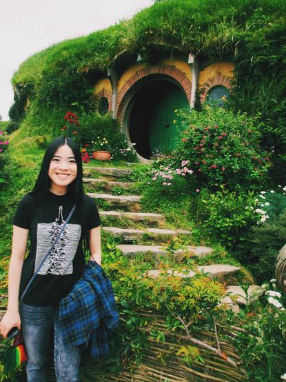 2014 photo of Chicago artist Jenny Lam at Bag End in Hobbiton movie set, Matamata, New Zealand