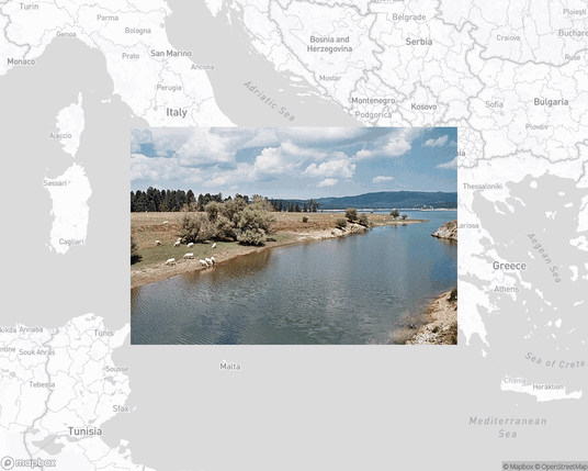 A photo of or from a national park from the linked website, overlaid on a cropped world map where it's located.