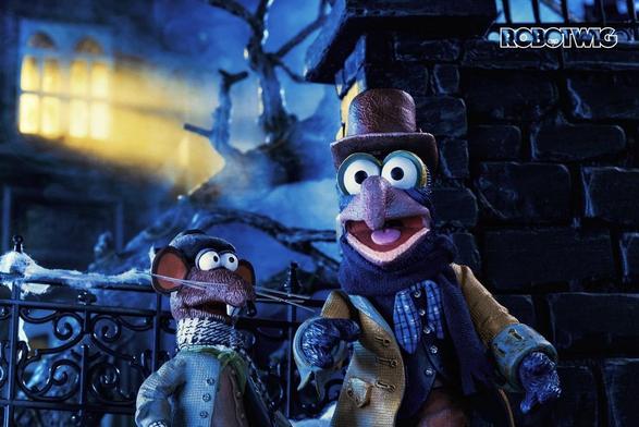 Rizzo and Gonzo stand outside Ebenezer Scrooges house in the dark from a top window comes a beam of light