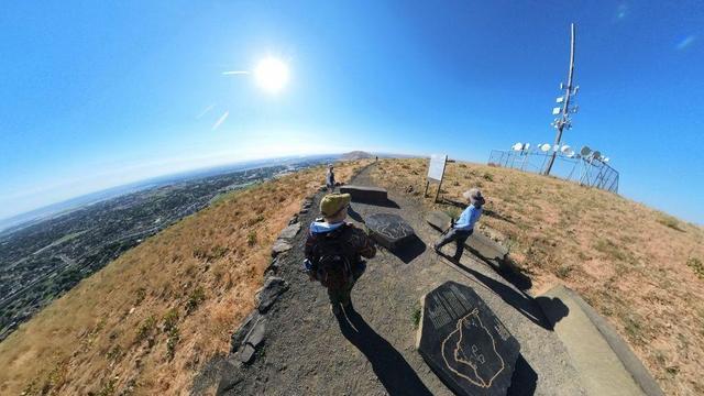 A desert mountain hiking trail scene from the Tri-Cities area of eastern Washington State under clear blue skies.