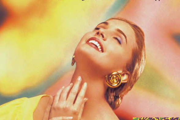 1994 Glamorous Woman with Large Gold Earrings

The image displays a woman exuding elegance and joy, her face lifted in an expression of pleasure as she gazes upwards. She has blonde hair styled away from her shoulders, adorned with large gold hoop earrings that reflect the light. Her makeup is polished, featuring prominent eyelashes and red lipstick, which adds to her radiant appearance.

The image does not contain any readable text aside from a watermark at the bottom right corner in yellow font on a multicolored background.