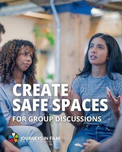 Two women of color sit in the middle of a group holding an engaged conversation. Text says: "Create Safe Spaces for Group Discussions". The Journeys in Film logo is in the bottom right corner.