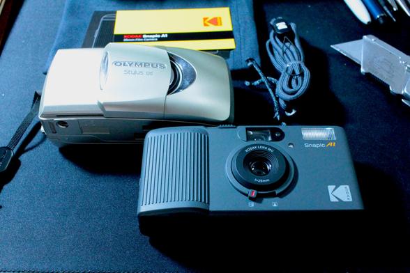 A comparison photo with my Mju (Stylus) 120 on the left, and my Snapic A1 on the right. The cameras are very similar in size other than the Mju being a bit thicker front to back.