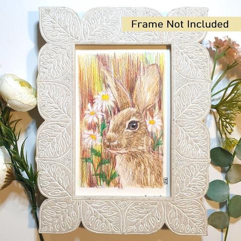 A tiny portrait drawing of a little bunny rabbit in colour. The rabbit is brown with a background of daisies and multicolour marks.
An original art work, please note that the frame is not included.
Colour pencil on white acid free artist watercolour paper (postcard size).
Approximately 4 by 6 inches (10.16 x 15.24 cm) will fit into a standard 4 by 6 inch photo frame.
The drawing will be in a clear envelope so you can view it before framing.
