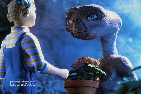 ET holds a pot of flowers whilst saying goodbye to Gertie as she