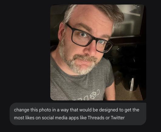 A person with glasses and a beard is taking a selfie and looking up at the camera with a prompt reading change this photo in a way that would be designed to get the most likes on social media apps like Threads or Twitter