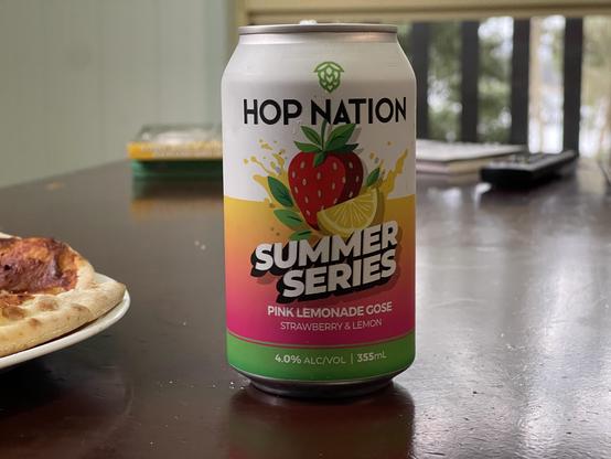 A beer can with a cartoon strawberry and lemon on it.