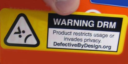 -a "Image that says 'Warning DRM | Product restricts usage of invades privacy. defectivebydesign.org.'"