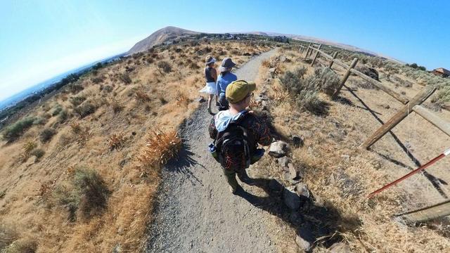 A desert mountain hiking trail scene from the Tri-Cities area of eastern Washington State under clear blue skies.
