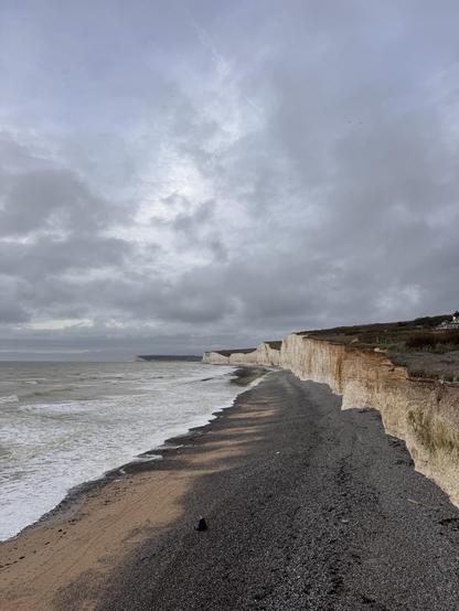 A view from Birling Gap along the coastal edge. White cliffs on the right, the sea on the left.