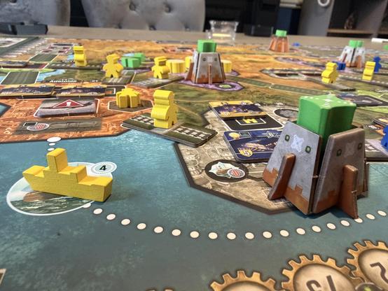 Close up of the Nucleum Australia expansion map. Yellow boats and Meeples. A Nucleum driven power station near the front.