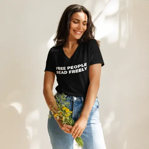 A black v-neck t-shirt featuring the linocut-carved text “free people read freely”