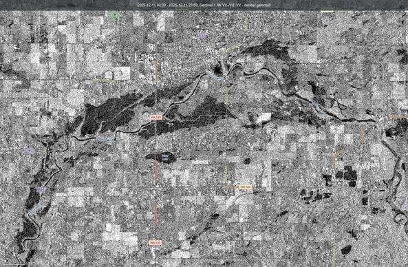 Image showing dark areas, post rainfall near Lynden, W-- water in what is a flood plain but nowadays is used for farming.