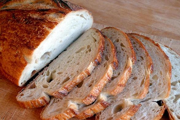 Slices of the loaf in the previous image showing a fairly dense crumb with only a few larger bubbles