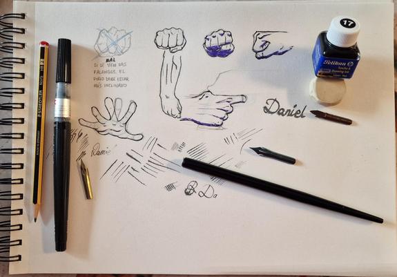 Photograph of a page of my sketchbook where I have sketched some hands. Some of them are inked with brush, and a bunch are inked with nib pen. There are also lines I've done to try out my nibs, and my name a couple of times.