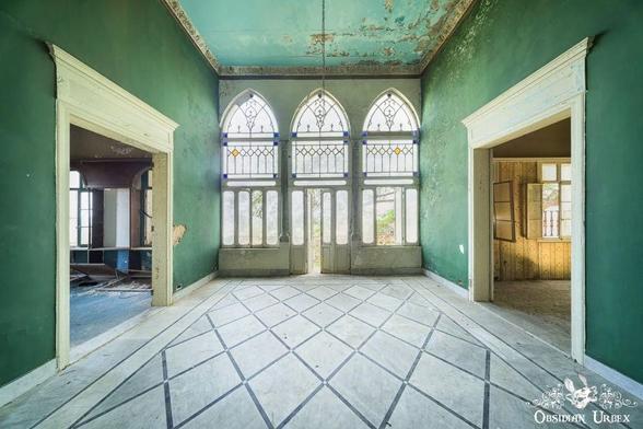 green room with a triple arch window at the far end, and doors either side