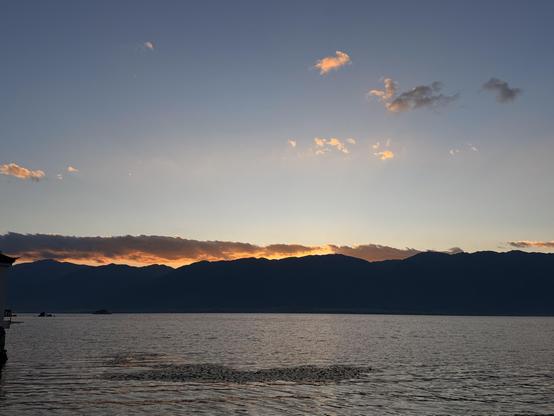 Scenic sunset view with mountains at lake Erhai in Yunnan, China