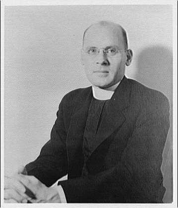 The image is a black and white photograph of an older man wearing glasses, dressed as a priest with his hands clasped in front of him. He has short hair, appears to be balding at the top, wears round-framed eyeglasses, and sports a clerical collar. The background is plain, emphasizing the subject without any distractions.

Additional information provided states that this portrait likely dates from approximately 1920-1950 based on style clothing and photographic techniques of that era. It also mentions "Horydczak, Theodor," who could be a reference to an individual or artist associated with the photograph; however, no further context is given.

The source of this image appears to come from Georgetown Preparatory School in Maryland, indicating possible educational significance for Horydczak's portrait.