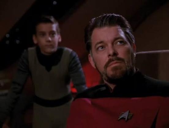 A slightly older Riker with some graying hair and boy around age 10 in background