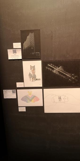 First half of my art. On top is the Elbphilharmonie with silver ink on black paper. Beneath is "calico/xxy". on the right side a technical drawing of my macro rail, also silver on black paper. Below is the "pride moth" and "everyone likes cat photos" on white paper. on the sides of each drawing is a card with the names. on the left side are 2 cards with QR codes and links to my profiles and the making of video linked here.