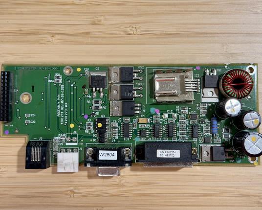 The top of a PCB. Along one side is a board to board connector and there is a row of ports across the bottom.