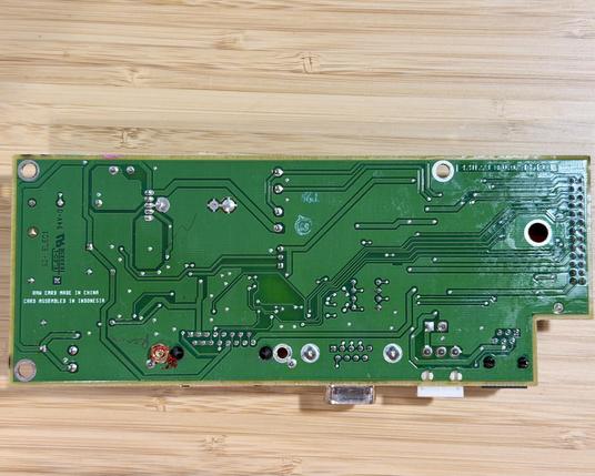 The bottom of the PCB. Solder points, traces and copper fills are visible.
