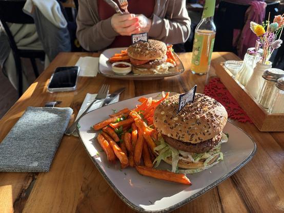 Photo of a vegan burger with sweet potato fries.