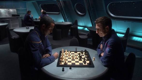 Malcolm and Mayweather who are possessed by alien beings playing chess in the mess hall