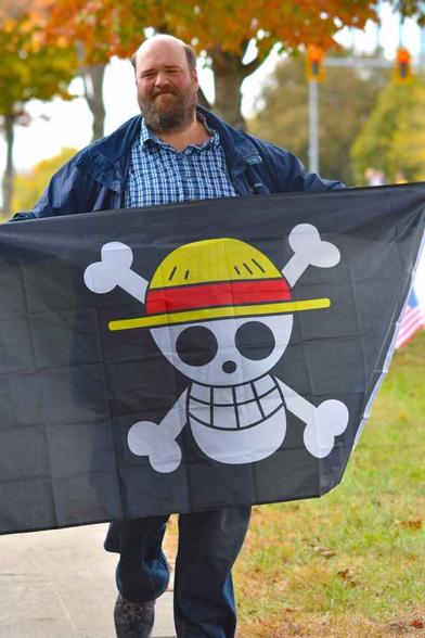 protester holding one piece pirate flag outdoors
