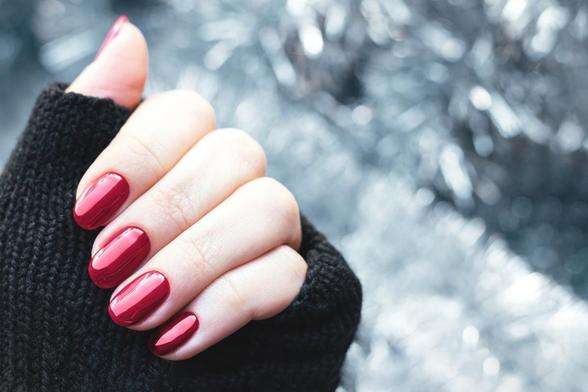 Una mujer enseña su manicura navideña (Getty Images/iStockphoto)