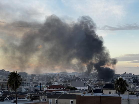 Photo: black smoke rising in the (otherwise beautiful) twilight sky over the Mission District in San Francisco