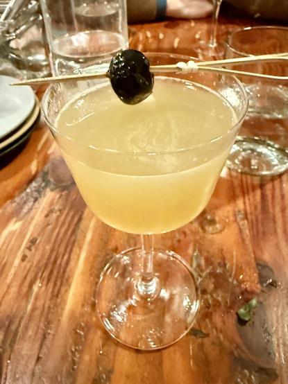 Cocktail with cherry garnish on a bamboo spear