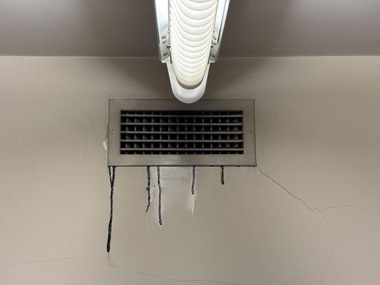 An air duct grate in the library with some long black drips running down the wall. (Dry to the touch I’m pleased to report.)