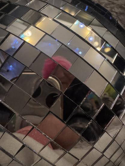 A reflection in a glitter ball. You can just make out Clair's pink hair.