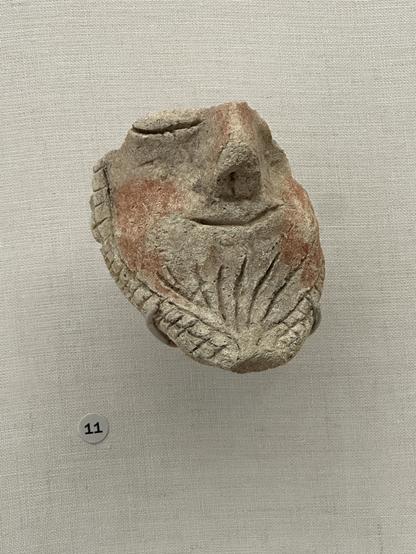 An ancient fragment of a chill af guy with a beard