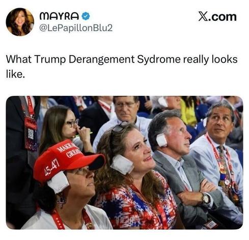 Screenshot of a tweet by MAYRA reading “What Trump Derangement Syndrome really looks like.” Below is a photo of people seated at a political convention wearing headphones or ear coverings, some with “Make America Great Again” hats, looking up toward a stage.