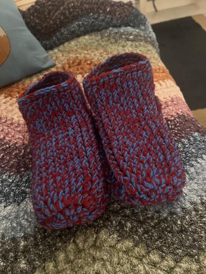 A pair of red and blue double stranded house slippers