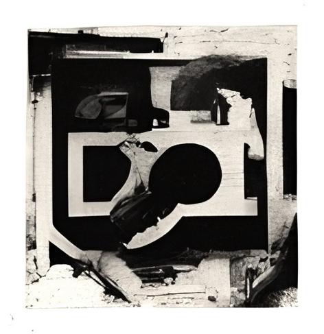 An arrangement of mutually incompatible forms in a two-dimensional plane suggests the simultaneous existence of opposites. A dominant white rectangle, itself containing a perfect black circle (an absolute unit of non-density), sits off-center, defying traditional balance and proportion. This central void is a "syzygy"—an unexpected alignment of shapes that creates narrative and challenges conventional logic.
Fragmented, collaged elements, perhaps machine components or architectural remnants, surround this central focus, their origin and function unknown, which is itself an "imaginary solution" to a non-existent problem. The overall composition is a "pataphor," an extended metaphor that creates its own reality independent of traditional representational stricture, using the facade of similarity as a basis for entirely new, illogical articulations. The image presents a universe supplementary to our own, one governed not by general laws but by the laws of exception and sporadic accident.