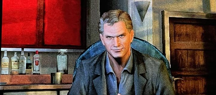 A person sits in a chair within a room featuring a bar area. Behind them, a shelf holds multiple bottles of various sizes (some with labels), a metal cup, and a red panel. To the right, there is a wooden door with a metal latch and a triangular wall fixture. The background includes a textured wall and a wooden door frame.