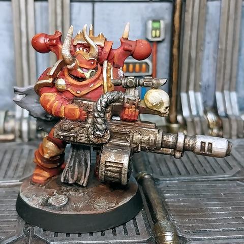 A World Eater space marine carrying a reaper autocannon.