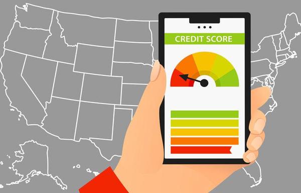 A hand holding a smartphone displaying a credit score gauge against a gray map background.